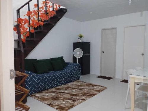 a living room with a couch and a staircase at tadzmahal in Pagadian