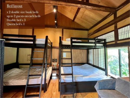 a bunk bed room with two bunk beds and a couch at SUMITSUGU HOUSE East in Kumamoto