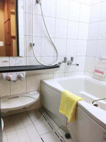 a bathroom with a tub and a toilet and a sink at Hashima - Hotel - Vacation STAY 51161v in Hashima
