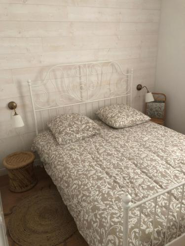 a bedroom with a bed with a white comforter at Maison Normandie in Fresles