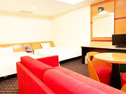 a hotel room with two beds and a red couch at Hashima - Hotel - Vacation STAY 52815v in Hashima