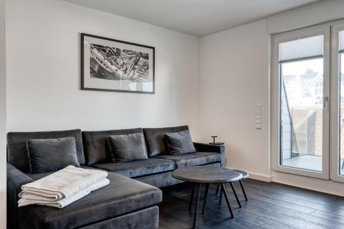 a living room with a couch and a table at Haus Noena in Norderney