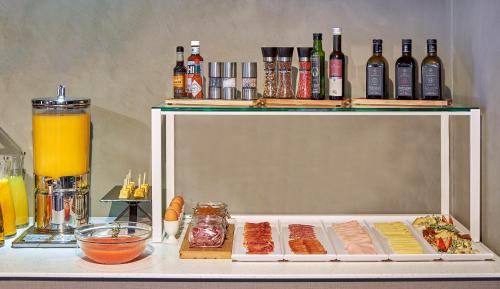 a table with some food and bottles of alcohol at NH Collection Andorra Palomé in La Massana