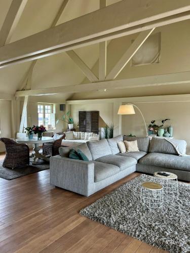 a living room with a couch and a table at The Loft in Melsele
