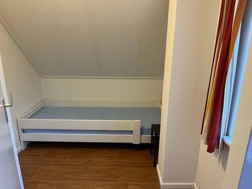 a small bedroom with a bed in a room at Holiday Home in Hellendoorn near Forest in Hellendoorn
