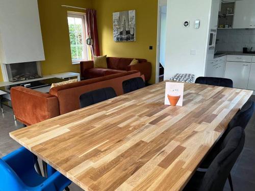 a wooden table in a living room with a kitchen at Holiday Home in Hellendoorn near Forest in Hellendoorn