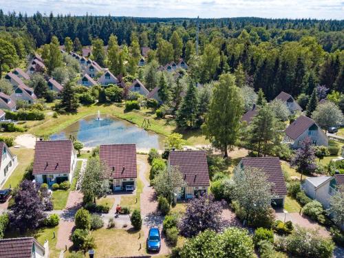 an aerial view of a home with a lake and trees at Holiday Home in Hellendoorn near Forest in Hellendoorn