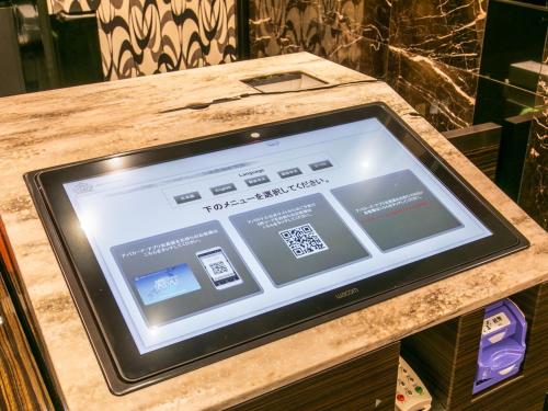 a tablet computer sitting on top of a counter at APA Hotel Sapporo Susukino Ekimae in Sapporo