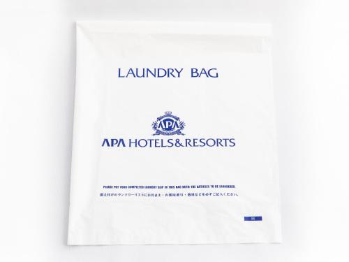 a catalogue of the laundry agency of australia with a white document at APA Hotel Sapporo Susukino Ekimae in Sapporo