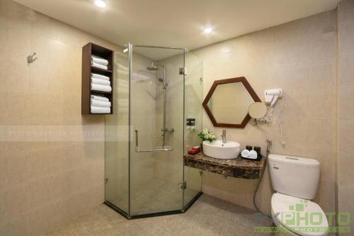 a bathroom with a shower and a toilet and a sink at Victory Legend Hotel - In Hanoi Central in Hanoi