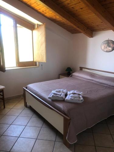 a bedroom with a bed with two towels on it at Casa Nando Relax e comfort home in Marina di Ascea