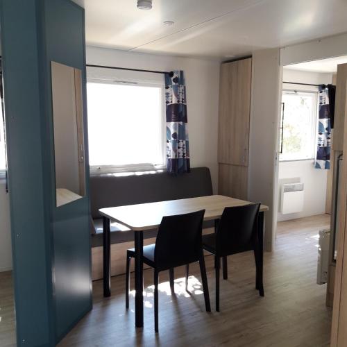 une salle à manger avec une table et des chaises dans l'établissement Village Océanique, au Bois-Plage-en-Ré