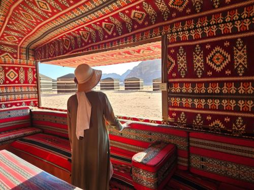 a man standing in a room looking out a window at joy of life in Wadi Rum