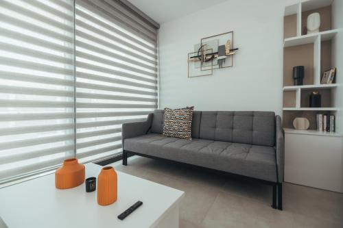 a living room with a couch and a table at Pearl Island Holiday Homes in Kérynia