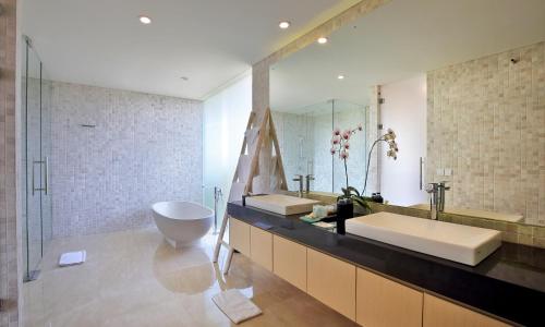 a bathroom with a sink and a large mirror at Villa Aquila in Seminyak