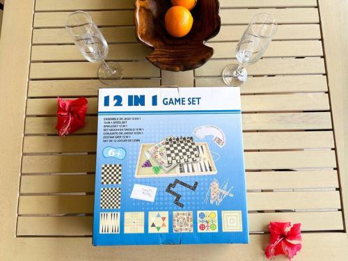 a table with two wine glasses and a box on it at FARE Moea - TAHITI in Arue