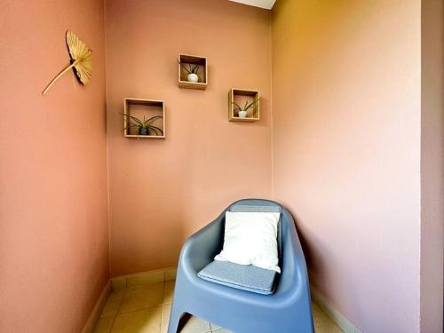 a blue chair in a corner of a room at FARE Moea - TAHITI in Arue