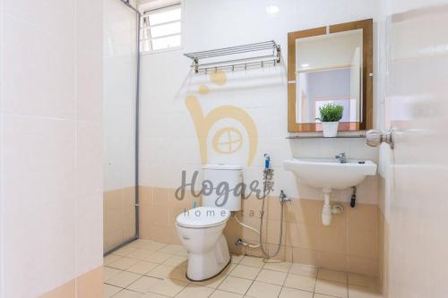 a bathroom with a toilet and a sink at Cozy Resort-Feel 3Bedroom-BBQ, Pool, Netflix 10pax in Seri Kembangan