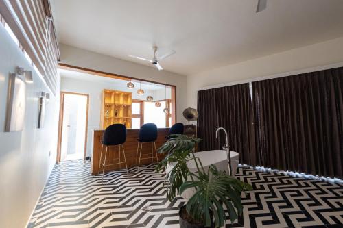 a living room with a table and chairs in a room at Asta in Ooty