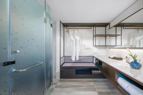 a bathroom with a shower and a sink at Satya Da Nang Hotel Han Market in Da Nang