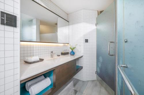 a bathroom with a sink and a mirror at Satya Da Nang Hotel Han Market in Da Nang