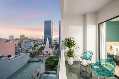 a balcony with a view of a city at Satya Da Nang Hotel Han Market in Da Nang