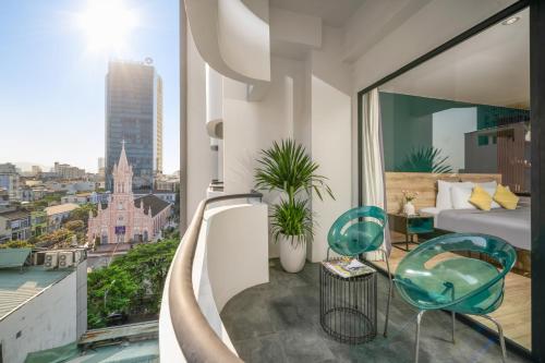 a hotel room with a balcony with a view of a city at Satya Da Nang Hotel Han Market in Da Nang