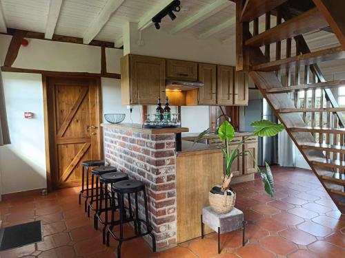 a kitchen with a counter and stools in a room at de Flyboys in Watou