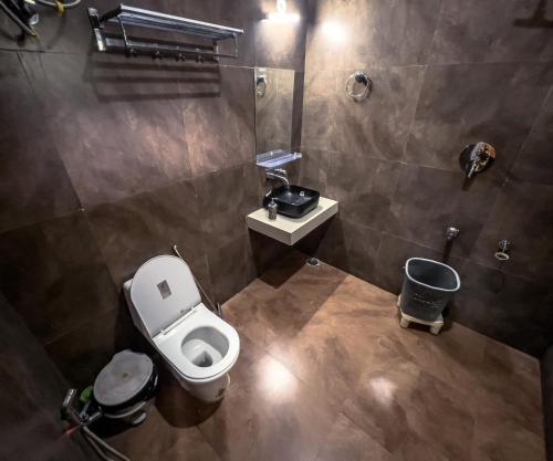 an overhead view of a bathroom with a toilet and sink at Delhi Height Kasol - Cafe and Hotel in Kasol
