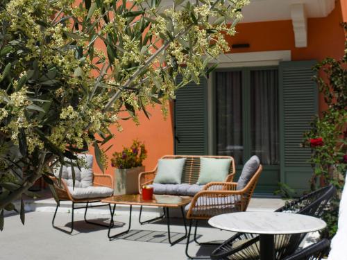 a patio with two chairs and a table and two tables at Saint george Hotel Parga in Parga