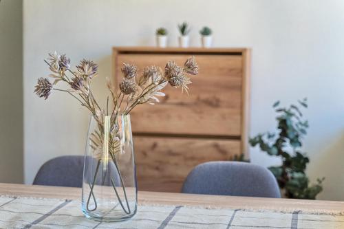 a vase filled with flowers sitting on a table at RELAX apartment Split area with private jacuzzi on terrace with mountain view in Srinjine