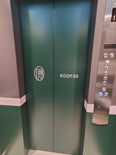a green elevator with a roazon sign on it at Skyline View - BTS Thong Lo in Bangkok