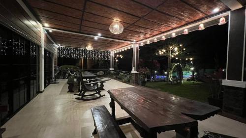 an outdoor patio with a wooden table and benches at CD NATUREVIEW in Matangtubig