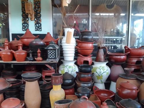 a pile of pots and vases on display in a store at Nan Bungalows Tetebatu in Tetebatu