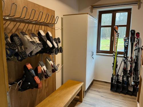 a room with a bunch of skis hanging on the wall at Chalupa U Kouzelné Lípy in Dolní Moravice