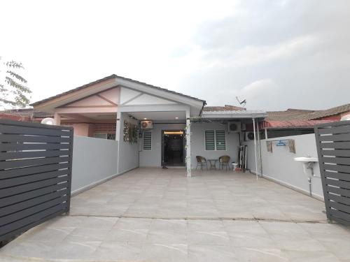 a house with a fence and a driveway at 5 Blossom Loveu Homestay in Seremban