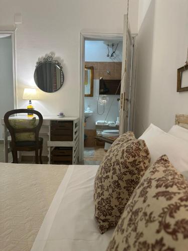 a bedroom with a bed and a desk at Civico 98 in Milazzo