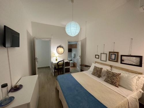 a bedroom with a bed and a desk and a room at Civico 98 in Milazzo