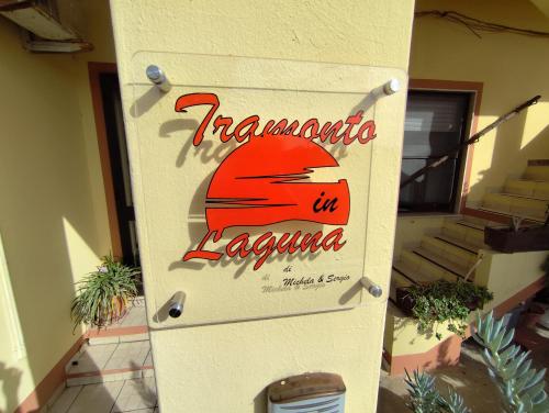 a door to a building with a sign on it at Tramonto in Laguna in Càbras