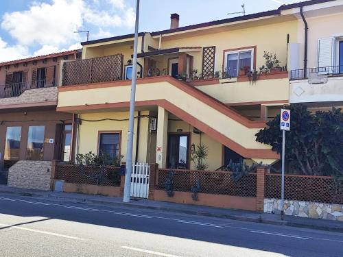 a yellow building with balconies on a street at Tramonto in Laguna in Càbras