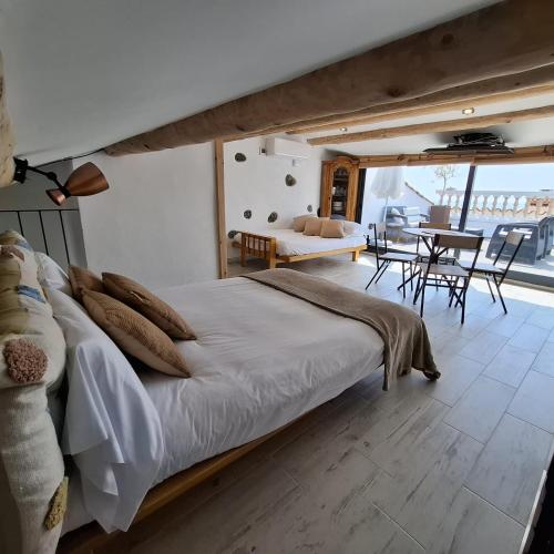 a bedroom with a bed and a table and chairs at Marina Vila House, Masnou in Masnou