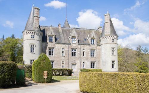 an old castle with two towers on top of it at L'Ecrin de Trédion in Trédion
