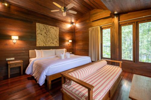 a bedroom with a bed and a couch in it at GajaPuri Resort Koh Chang in Ko Chang