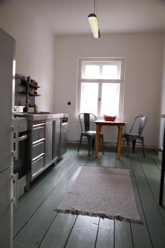 a kitchen with a table and chairs and a window at Grüne Villa in Bad Brambach