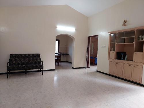a living room with a couch and a table at Caron Niron Two Bedroom Villa in Kodaikānāl