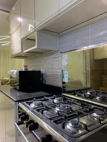 a kitchen with a stove top in a kitchen at مدينتي in Madinaty