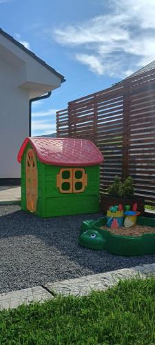 a childs play area with a toy house at Chata North Point Zuberec pod Roháčmi in Zuberec