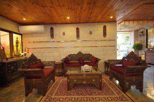 a living room with couches and a table in a room at Petra Plaza Hotel in Wadi Musa