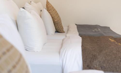 a white bed with white pillows on it at CM Park Hotel in Andong
