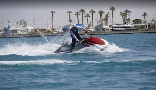 a person on a jet ski in the water at شاليه سي فيو بورتو مارينا عائلات - Porto Marina Sea View in El Alamein